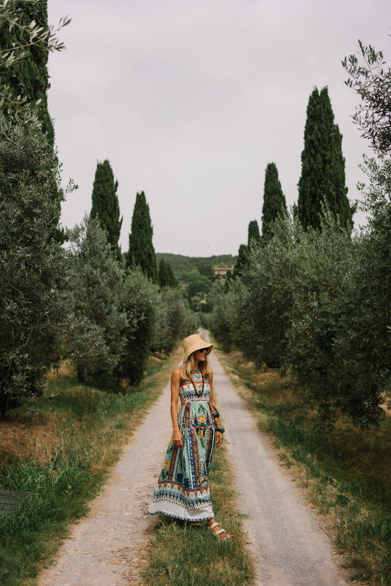 patterned maxi dress woven bucket hat cream sandals cream woven bag