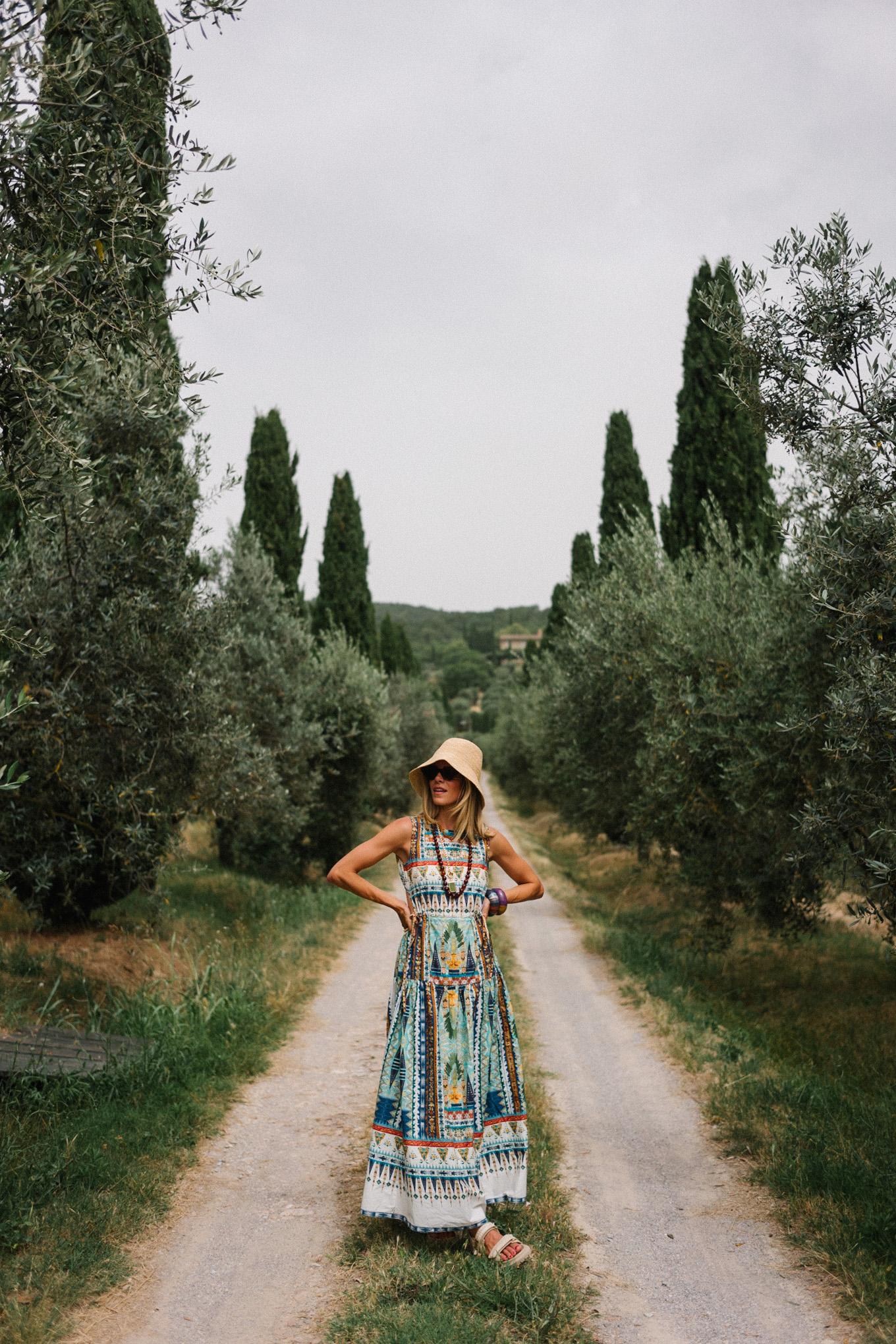 patterned maxi dress woven bucket hat cream sandals cream woven bag