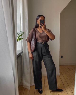 Lydia wearing black wide-leg trousers