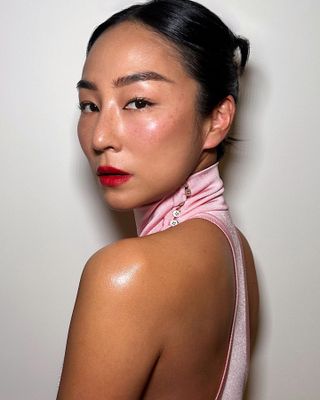 Greta Lee with middle part bun