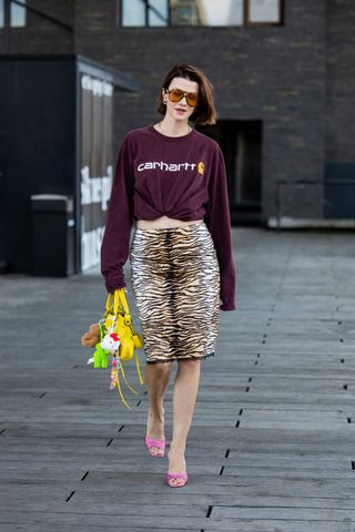 a woman wears a tiger-print knee-length skirt in Copenhagen