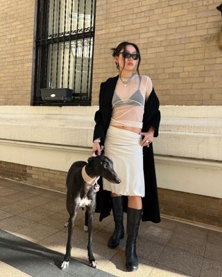 Influencer wears a skirt with biker boots.