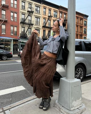 Influencer wears a skirt with biker boots.