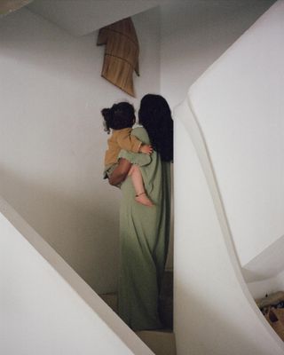 Monikh wears a pale green long maxi dress.