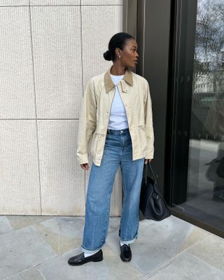 @nlmarilyn wearing a barn jacket in cream with jeans and loafers.