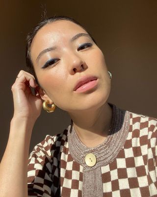 Content creator Marcela Alcala wears a sleek blue eyeliner look