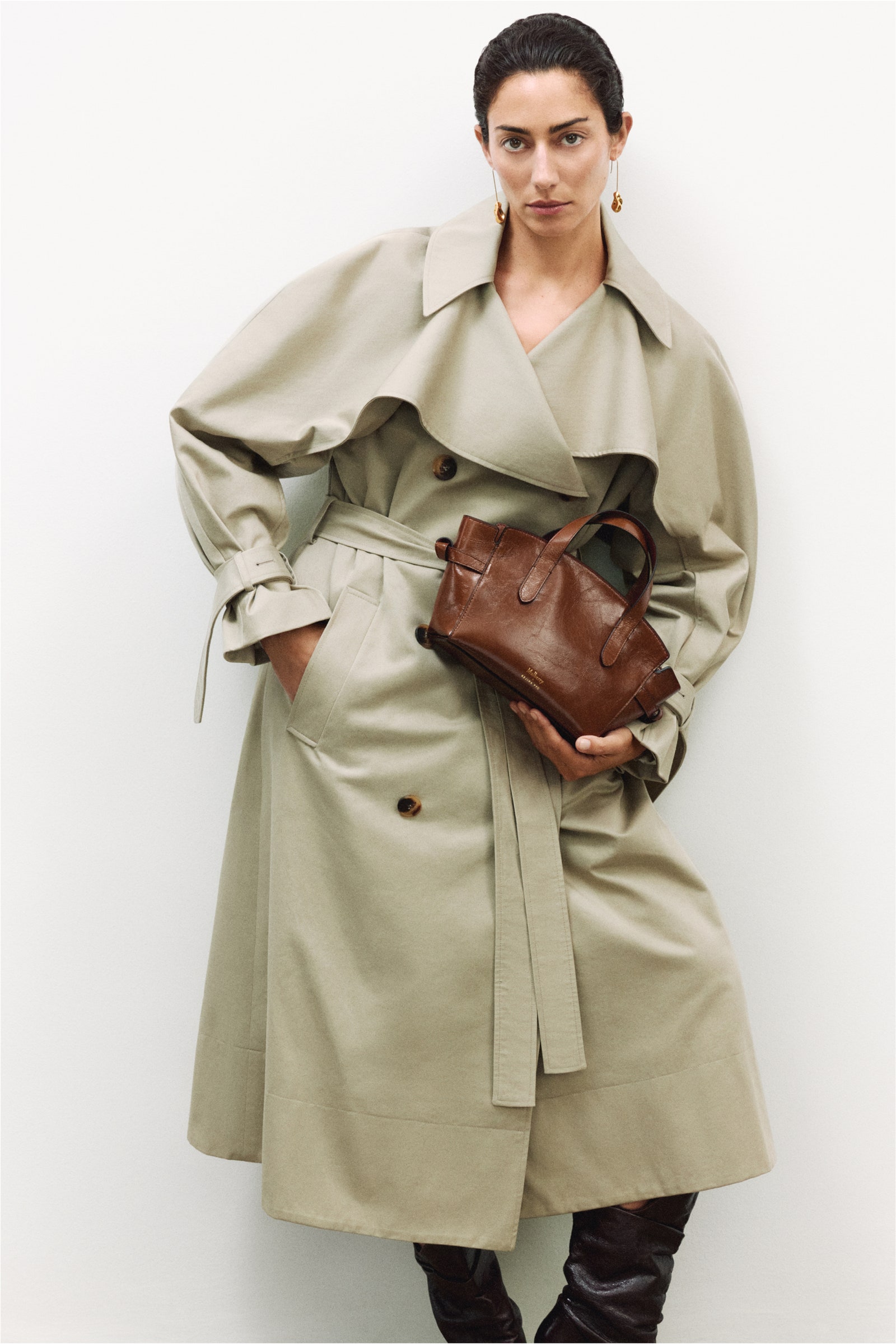 Image may contain Clothing Coat Overcoat Accessories Bag Handbag Trench Coat Adult and Person