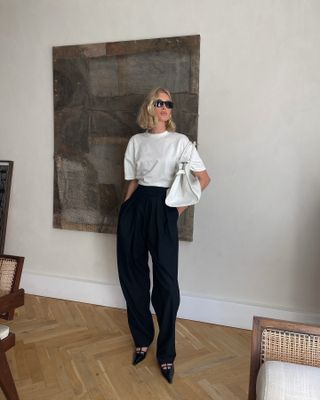 Elsa Hosk wearing a white T-shirt and black pants