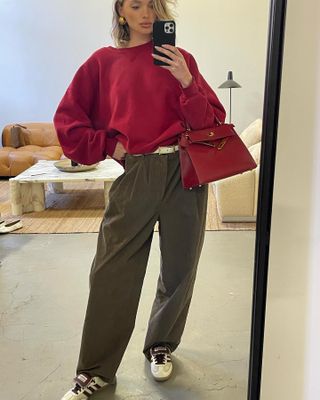 Elsa Hosk wearing a sweatshirt, trousers, and sneakers