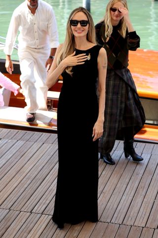 Angelina Jolie wears a black dress.