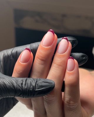 A french manicure with burgundy tips by Georgia Rae