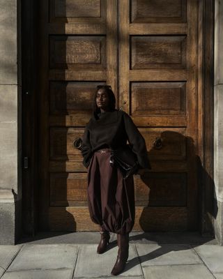 Influencer wears burgundy boots.