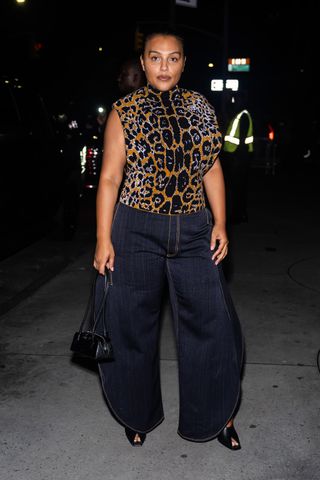 Paloma Elsesser wears a leopard-print top with wide-leg jeans