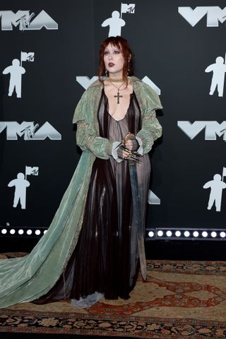 Chappell Roan wears a long dress and a cross necklace on the 2024 MTV VMAs red carpet