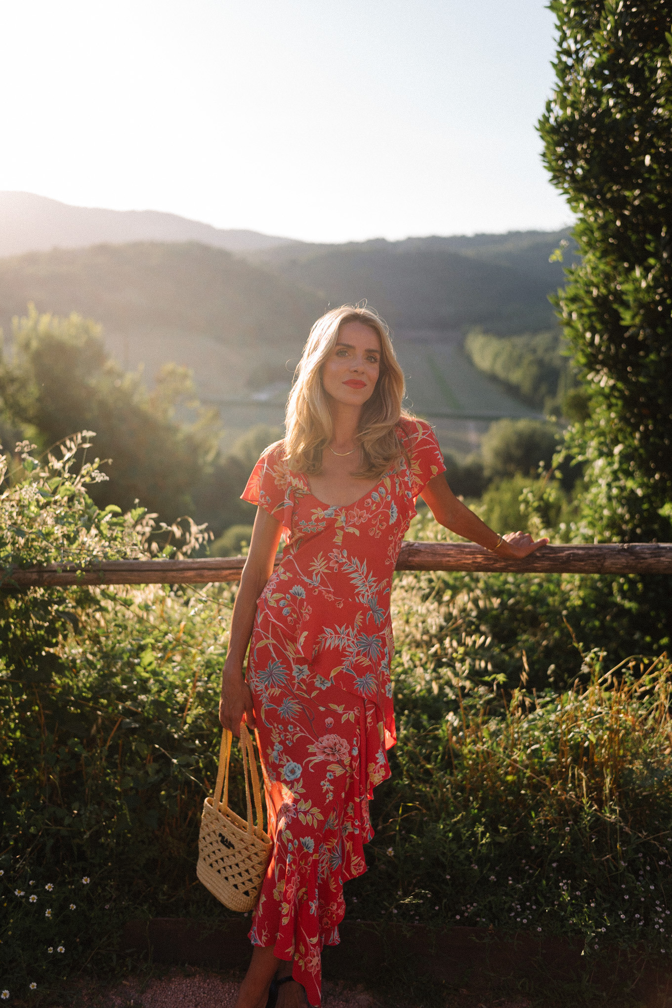 red floral midi dress straw bag