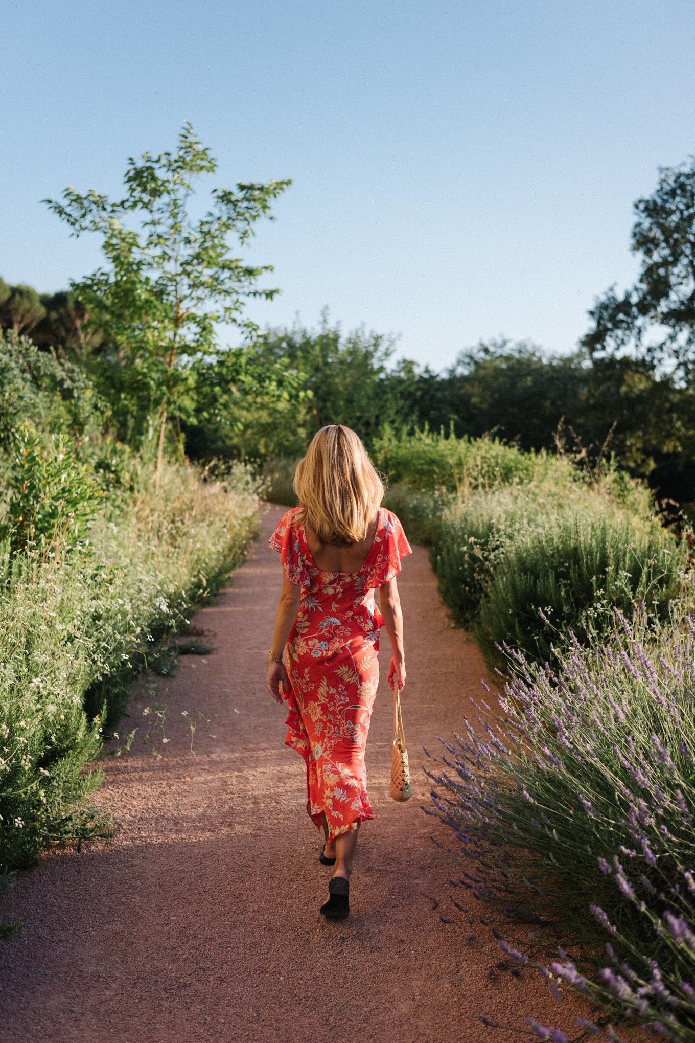 red floral midi dress straw bag