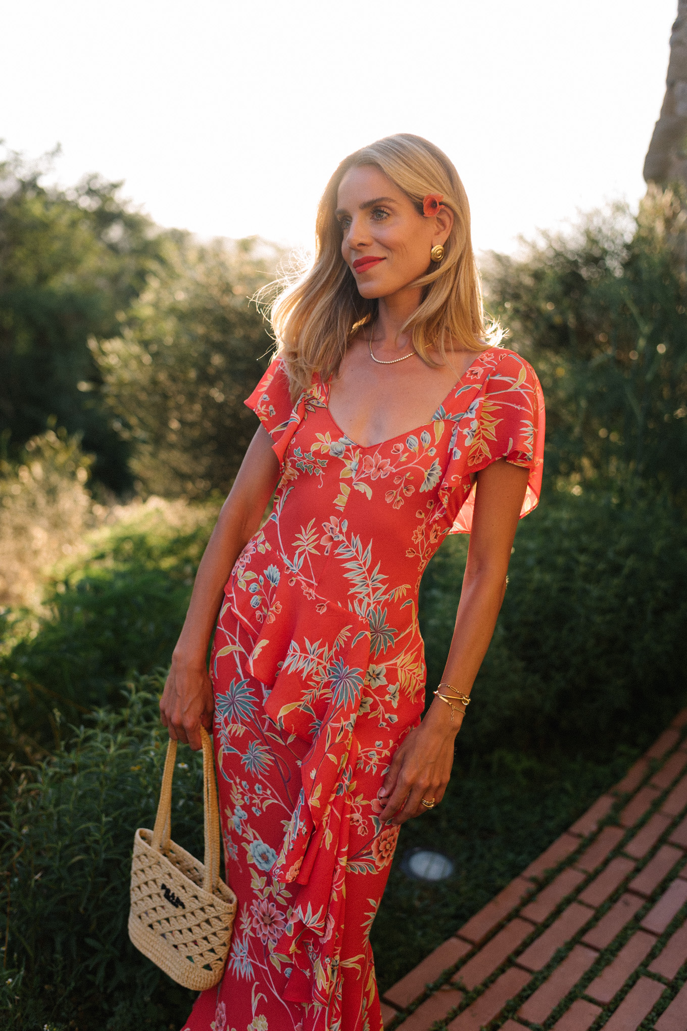 red floral midi dress straw bag