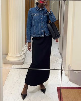 @sylviemus_ wearing a black dress and denim jacket