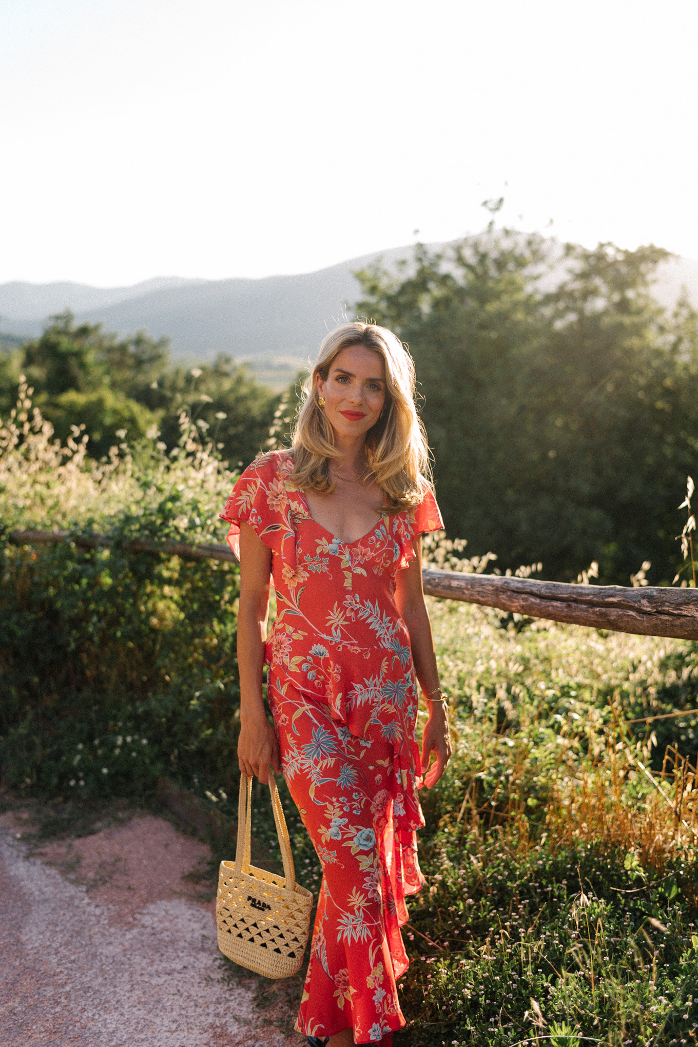 red floral midi dress straw bag