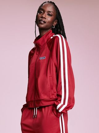 red track jacket with white stripes on the side