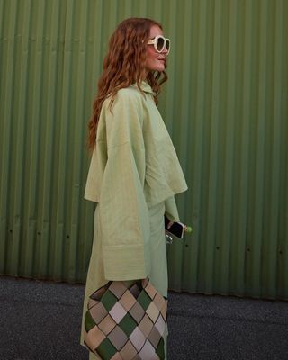 Green co-ords with checkered bag