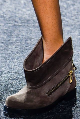 a close photo of a model on the JW Anderson spring 2025 runway wearing moto boots