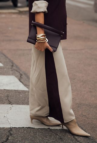 A woman wearing oversize jewelry during Milan Fashion Week spring/summer 2025.