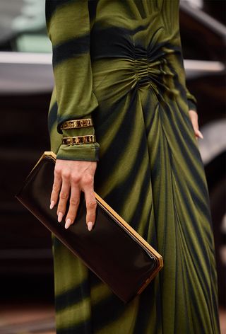 A woman wearing oversize jewelry during Milan Fashion Week spring/summer 2025.