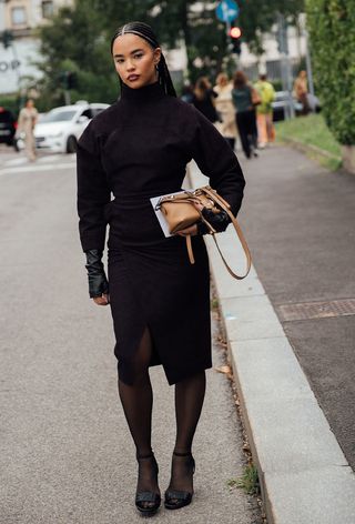 A woman wearing funnel neck trend during Milan Fashion Week spring/summer 2025.