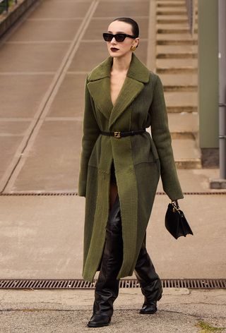 A woman wearing over-the-knee boots during Milan Fashion Week spring/summer 2025.