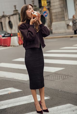 Milan Fashion Week spring 2025 street style photo of a woman wearing the wine red colour trend