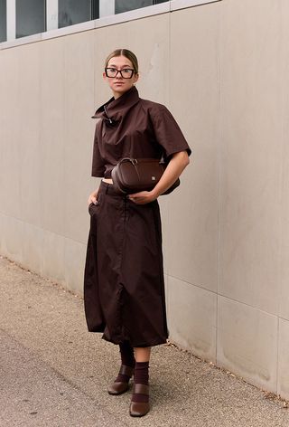 A woman wearing funnel neck trend during Milan Fashion Week spring/summer 2025.