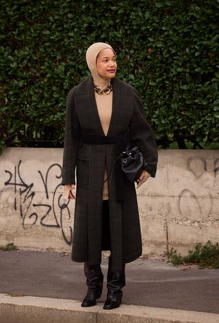 A woman wearing over-the-knee boots during Milan Fashion Week spring/summer 2025.