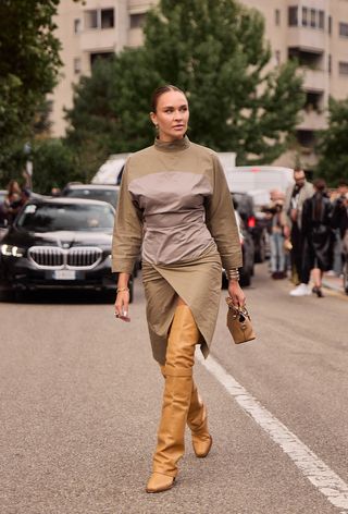 A woman wearing over-the-knee boots during Milan Fashion Week spring/summer 2025.