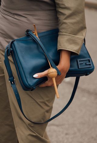 A woman wearing the bag charm trend during Milan Fashion Week spring/summer 2025.