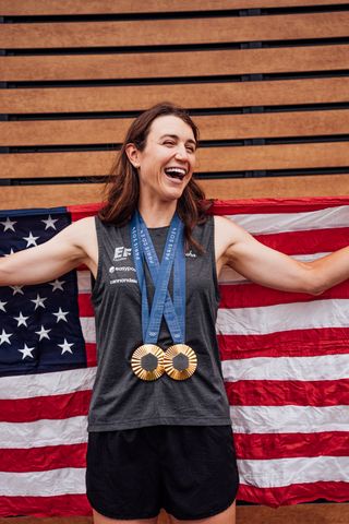 A photo of cyclist Kristen Faulkner wearing her two Olympic gold medals.