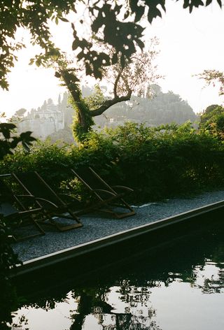 Scenic garden with pool and garden chairs