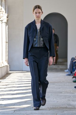 a model walks the spring 2025 runway during Milan Fashion Week