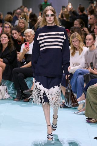 a model walks the spring 2025 runway during Milan Fashion Week