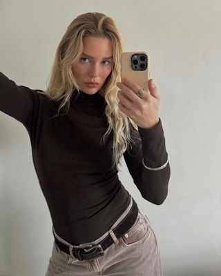 Content creator Megan Adelaide with beachy curls and a chocolate brown turtleneck