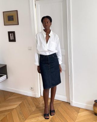 Sylvie Mus wearing a white shirt and dark denim skirt