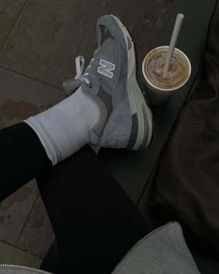 Influencer wears blue suede trainers.