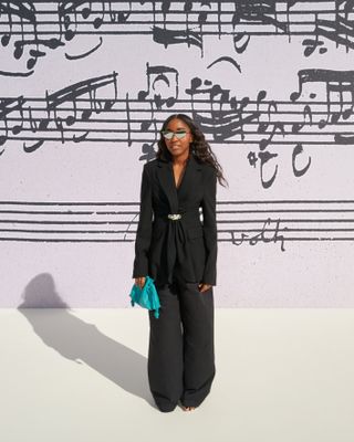 a photo of the celebrity, Ayo Edebiri, attending Loewe's spring summer 2025 runway show