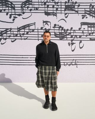 a photo of the celebrity, Dan Levy, attending Loewe's spring summer 2025 runway show