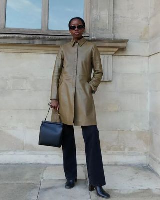 French fashion influencer Sylvie Mus wearing a chic fall outfit with black pants in Paris.