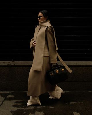 Woman wears beige scarf coat