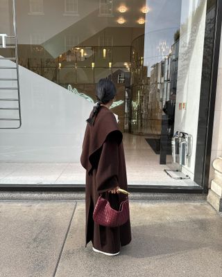 Colours That Go With Burgundy:  @monikh  wears a brown coat and carries a burgundy bag