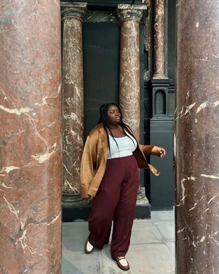 Colours That Go With Burgundy: @abimarvel wears burgundy trousers with a camel silk blouse