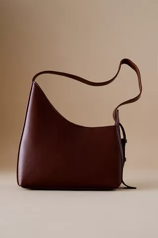 By Anthropologie Asymmetrical Buckle Shoulder Bag