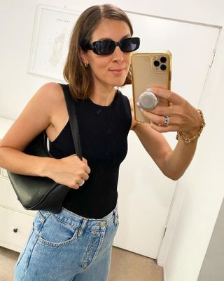 Fashion editor, Judith Jones, wearing black top, jeans and '90s sunglasses